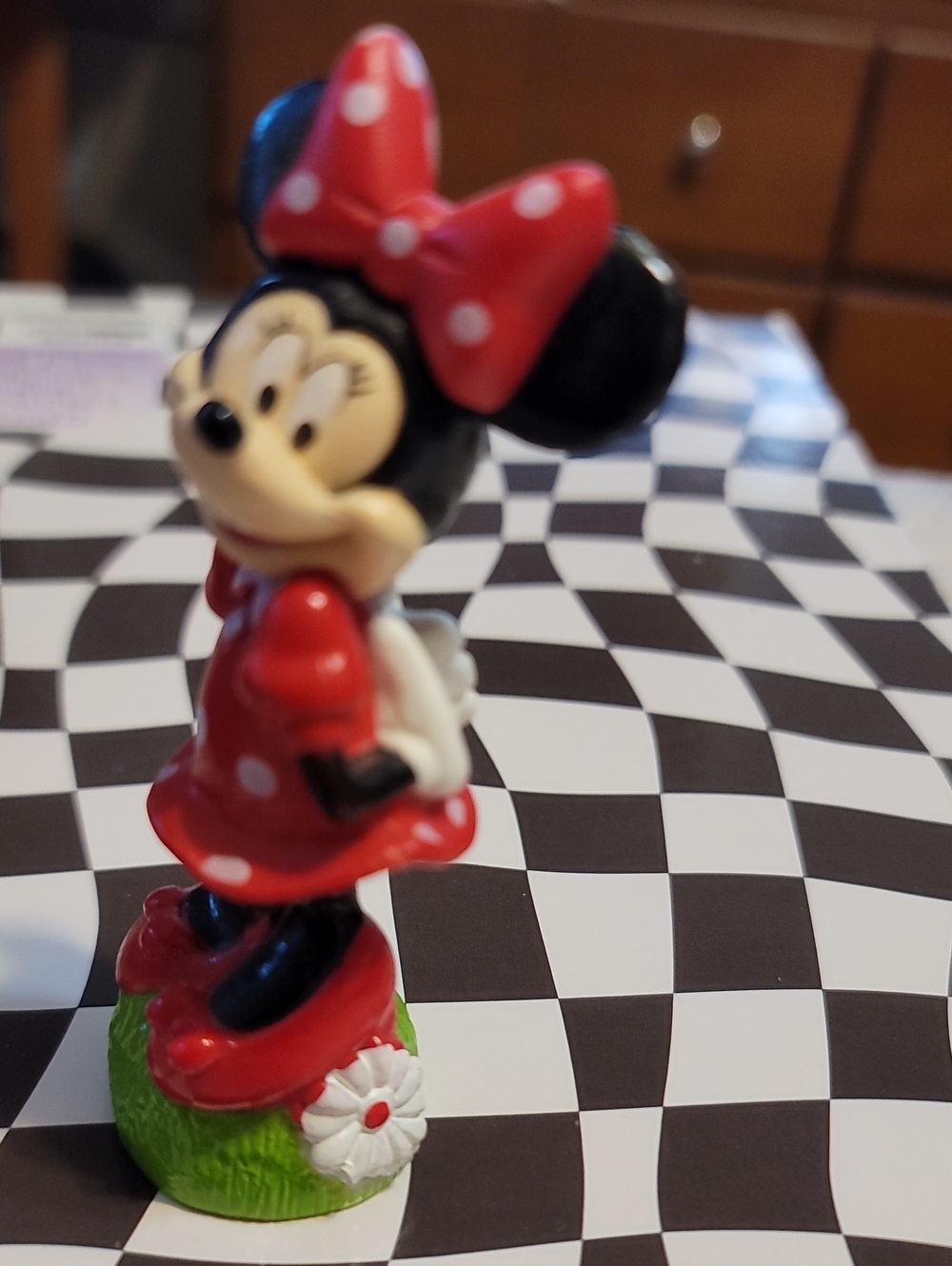 Minnie Mouse figurine wearing a red and white polka-dot dress